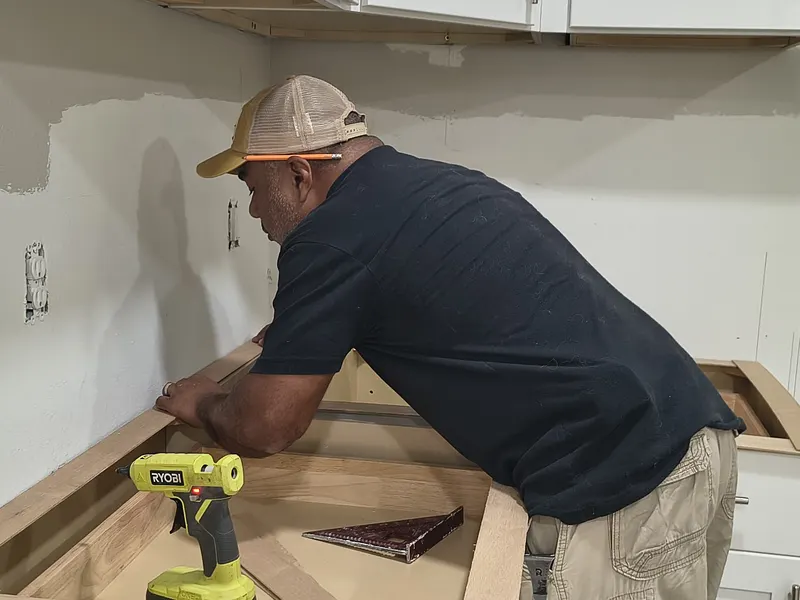 Fernando building a wooden template on new kitchen cabinets