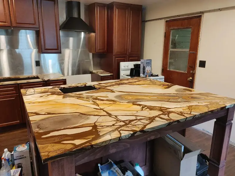 Gold and cream veined stone island on dark wood cabinets