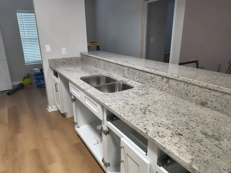 Speckled white stone kitchen counter with a double sink