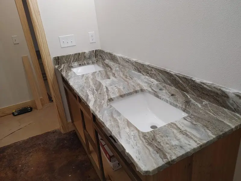 Brown and cream veined stone vanity top with two undermount sinks