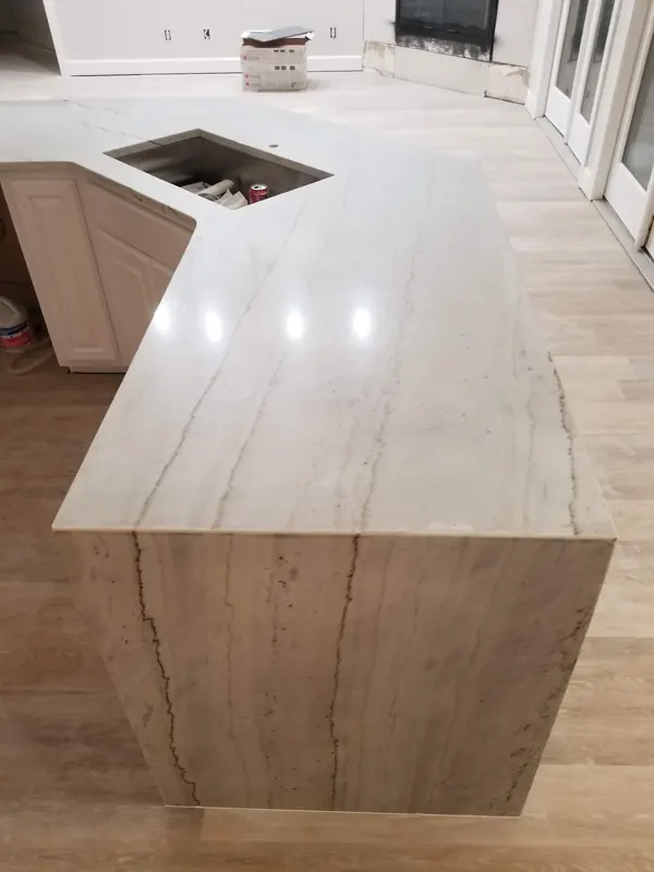 Light stone peninsula with a waterfall end and a sink cutout